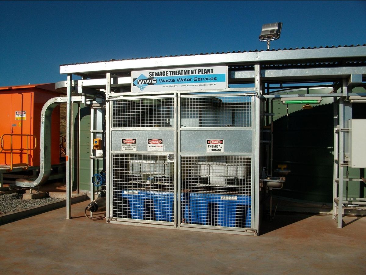 WWS packaged sewage treatment plant in service, chemical storage bund and plant signage in frame